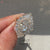 Oval diamond ring with baguette side stones and halo.