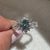 buy handmade engagement ring with round blue diamond and lab grown stones.