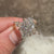 Marquise cut moissanite ring with vintage halo style.