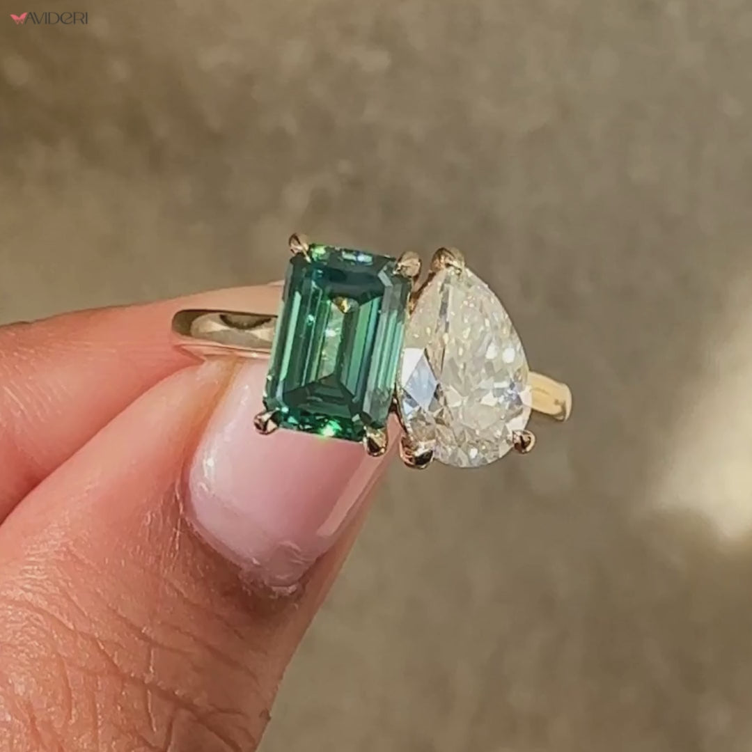 Avideri ring with pear and emerald cut in cathedral setting.
