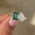 Avideri ring with pear and emerald cut in cathedral setting.
