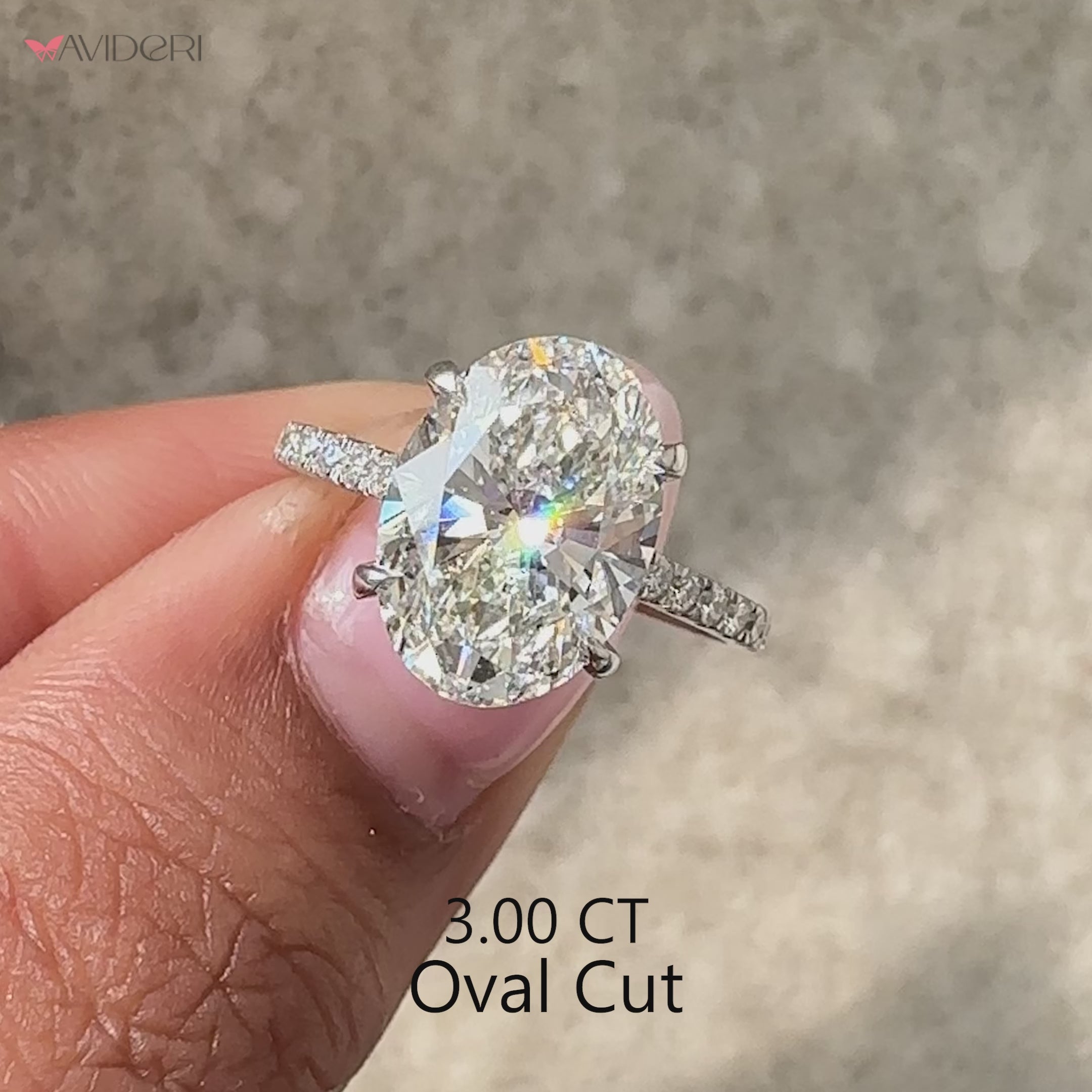 Oval diamond ring with hidden halo and pave accents.