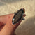 Avideri engagement ring with a graceful moval cut center.