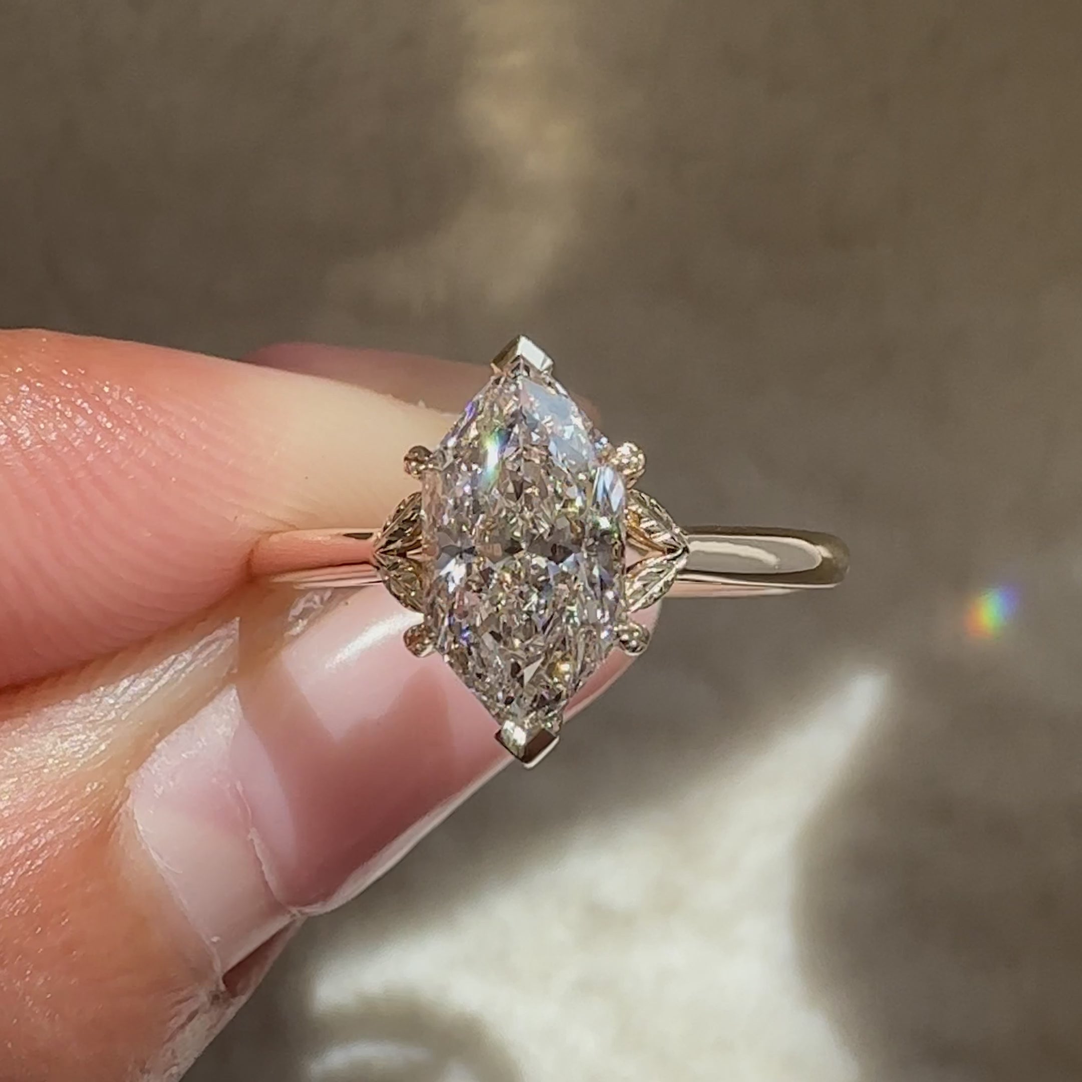 Marquise lab grown diamond ring with leaf setting.
