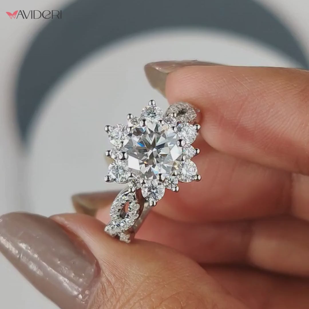 The flower halo engagement ring includes a delicate floral diamond halo.

