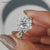 The flower halo engagement ring includes a delicate floral diamond halo.
