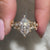 Marquise and round side stone in dutch marquise engagement ring.