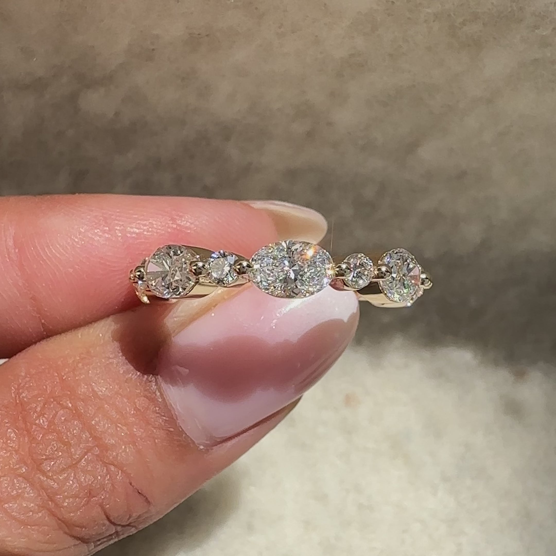 Wedding band with half eternity oval round diamonds.
