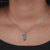 Pendant bezel setting highlights the gemstone's beauty.