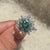 Modern cyan blue moissanite engagement ring.