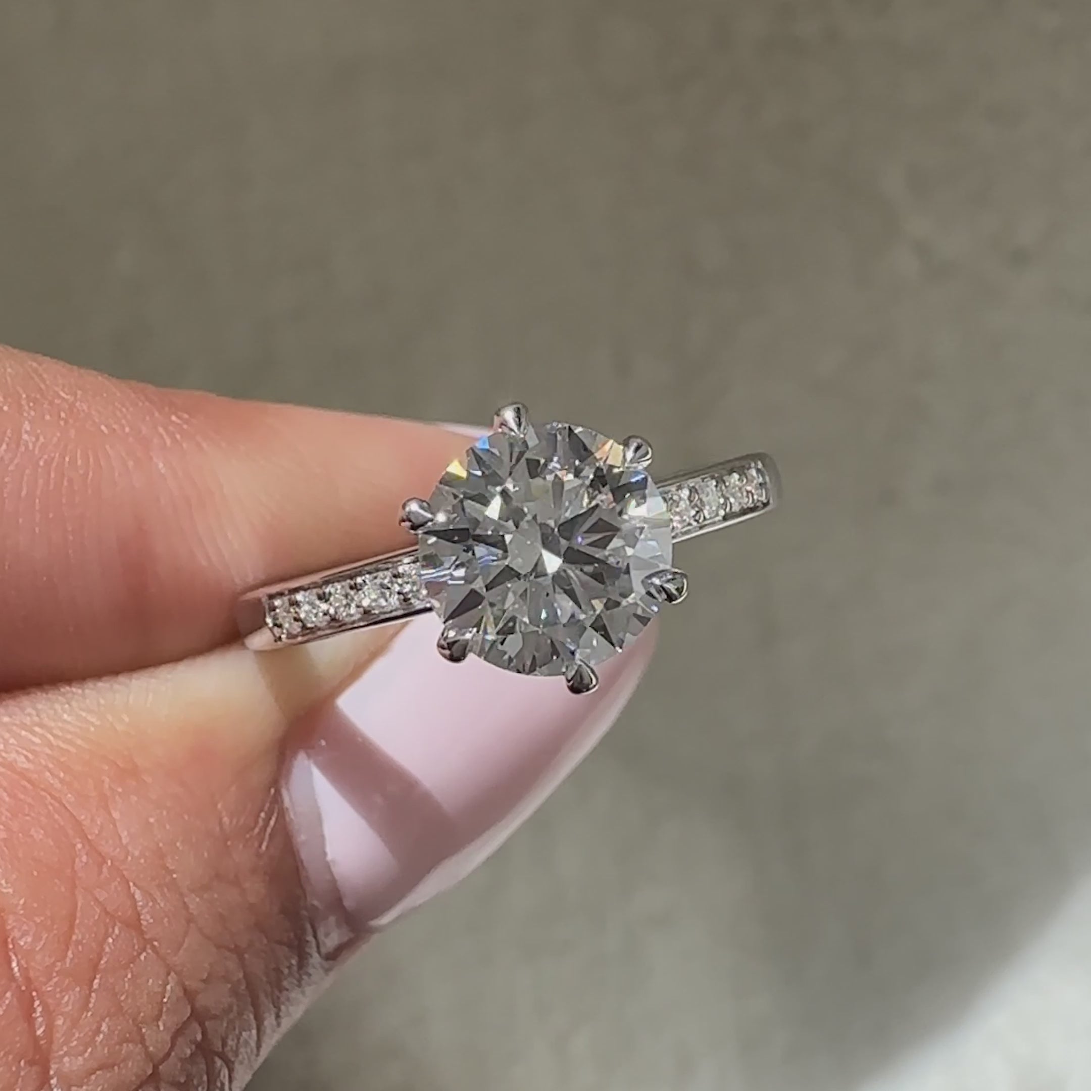 Round cut engagement ring with six claw prong design
