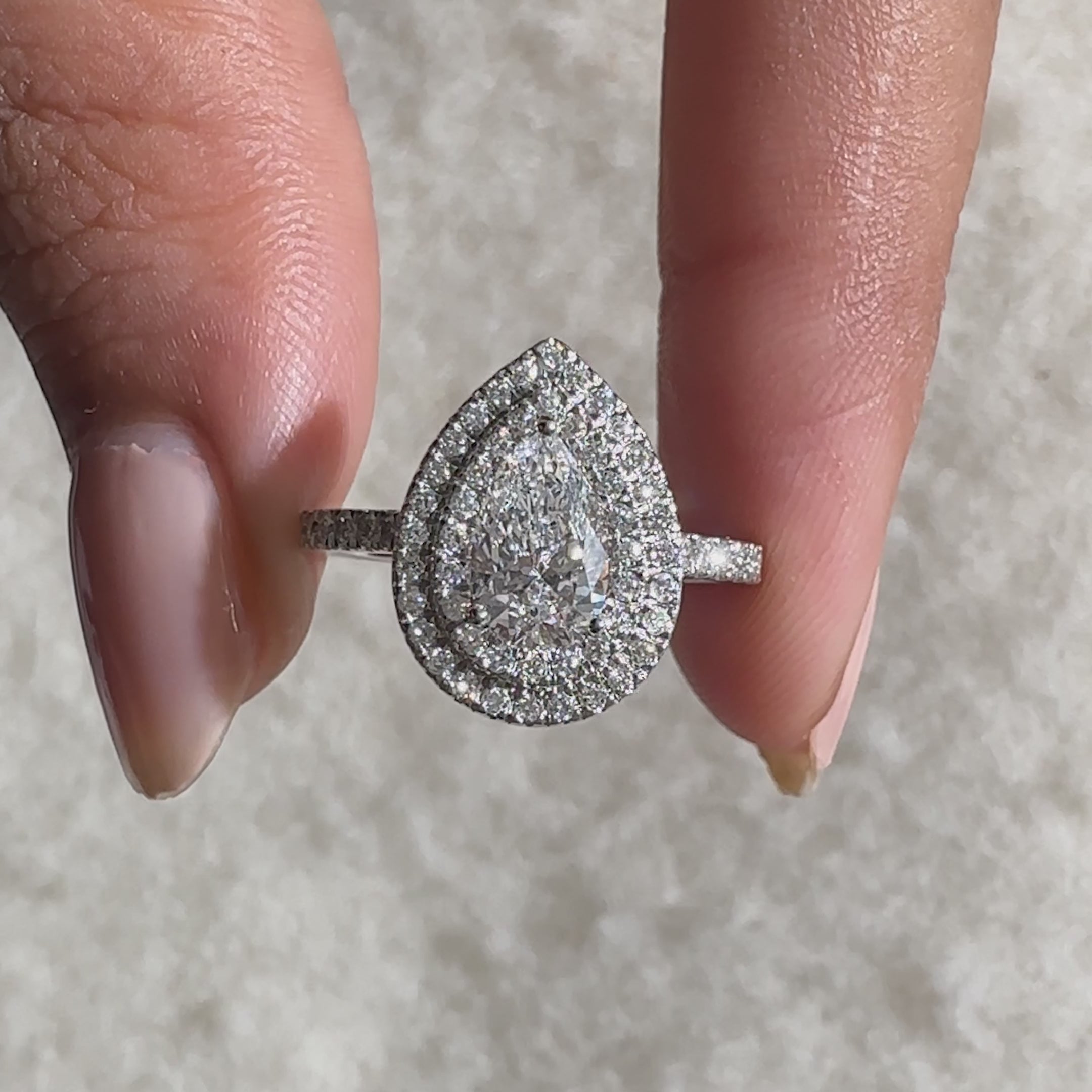Exquisite double halo pear engagement ring crafted for luxury.