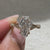 Coffin cut engagement ring with round side stones design
