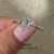 Round cut side stone with lab-grown diamond ring.
