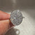 Cluster style round diamond ring with oval shape outline.
