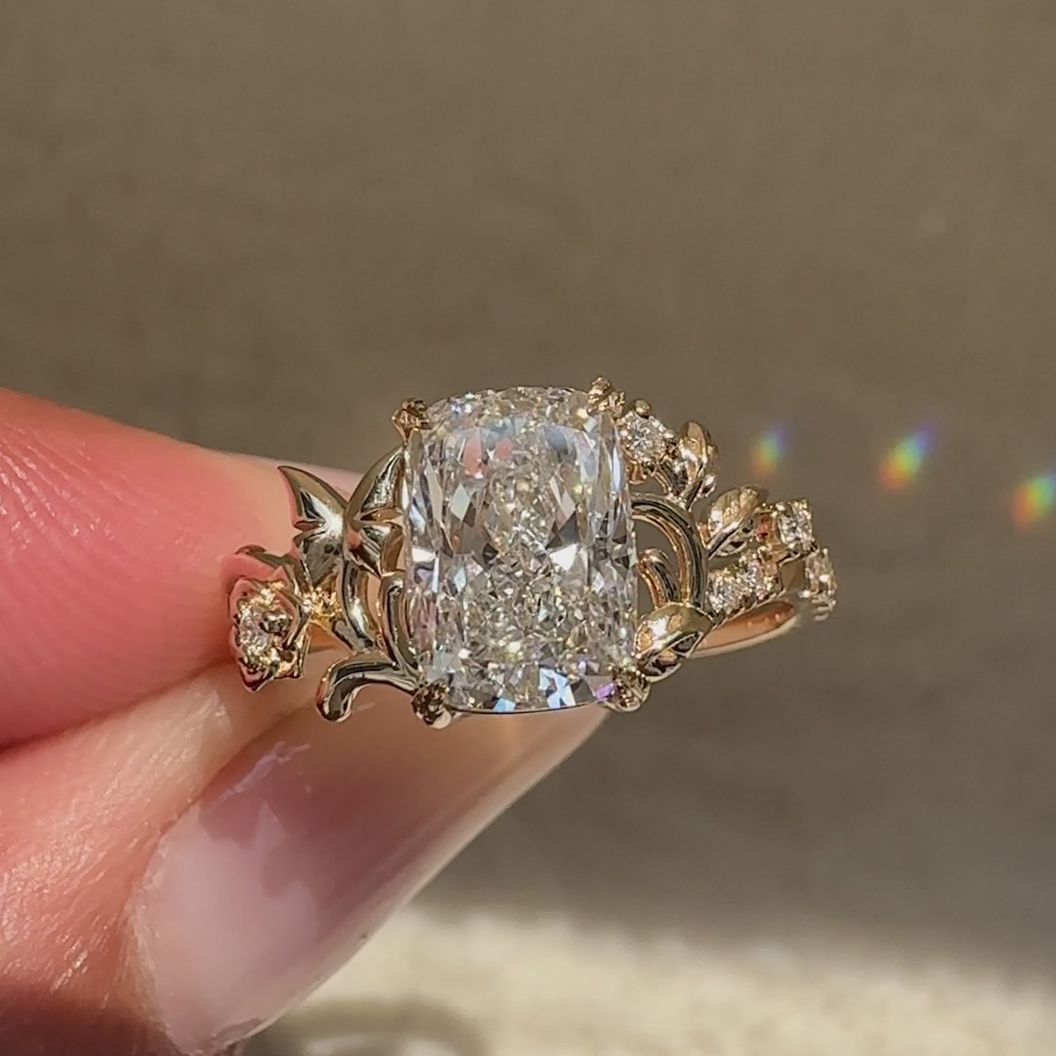 Cushion ring with signature butterfly prong style.
