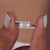 A ring with round side stones beside a center gem.
