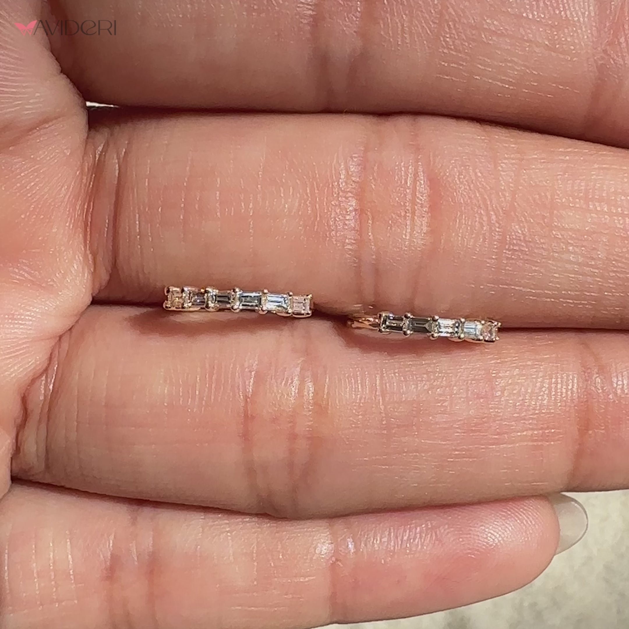 Pair of white gold hoop diamond earrings on display
