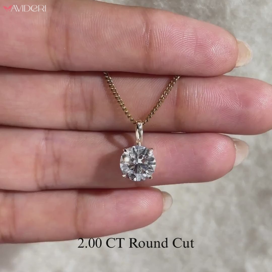 Round cut solitaire pendant as part of handmade jewelry collection.