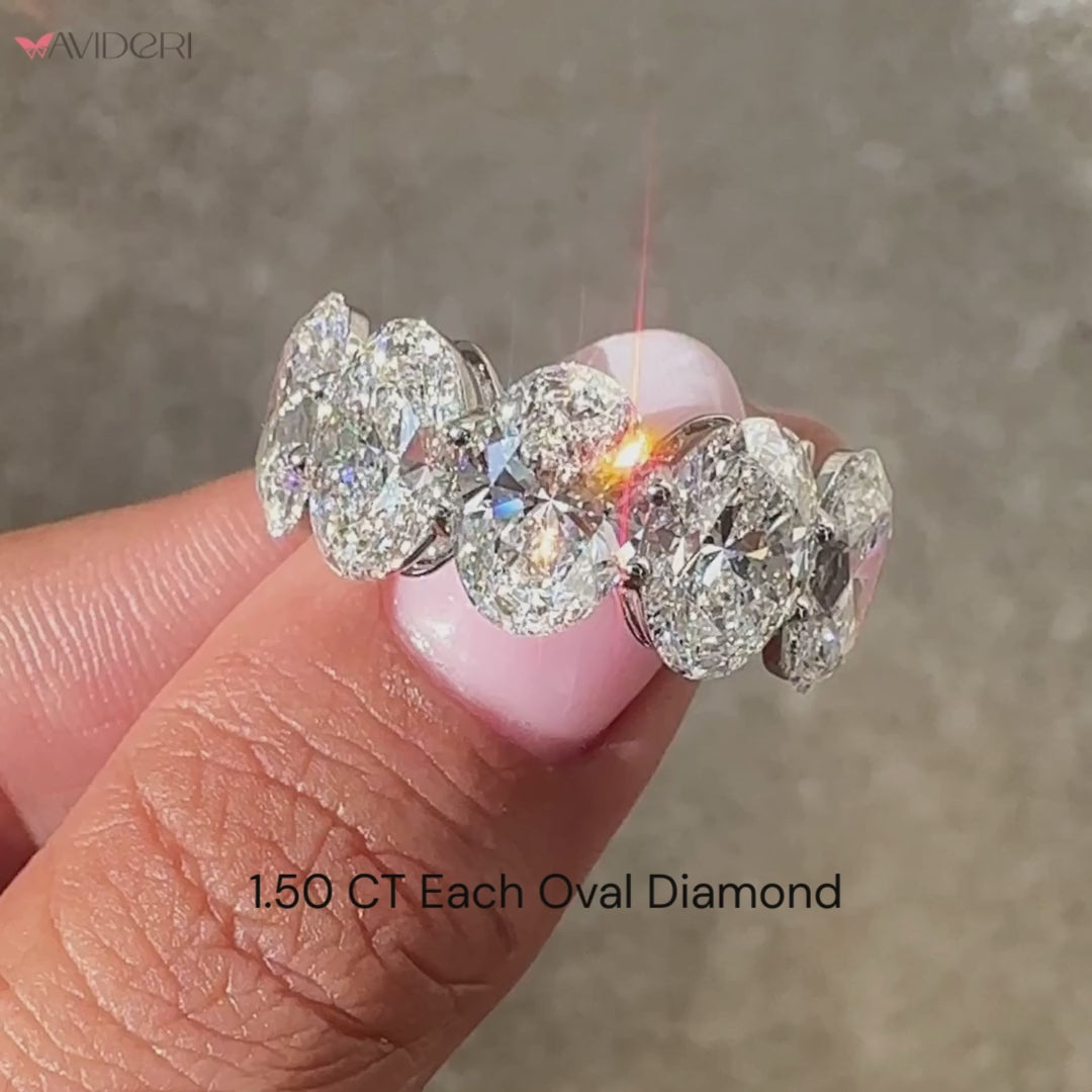 Simple white gold oval cut diamond band.