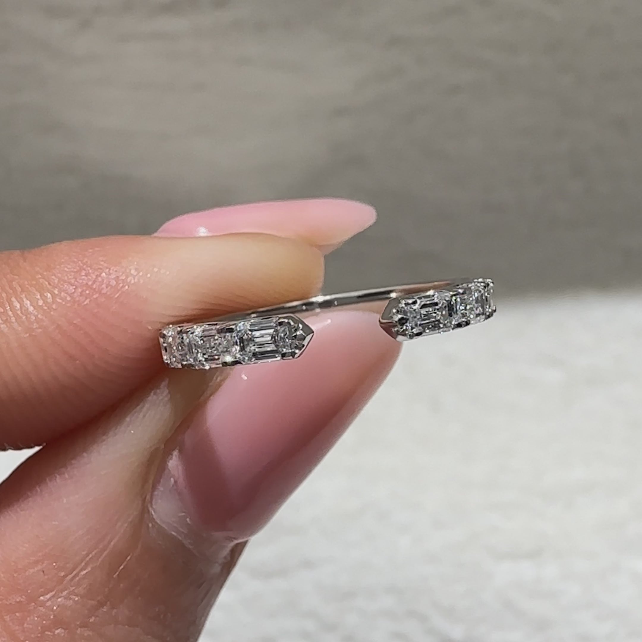 Open gap wedding band with emerald diamond stone arrangement
