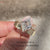 Lozenge diamond ring with four claw prongs.
