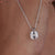 Moissanite solitaire pendant with an elegant and clean design.