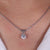 Four-prong pendant that highlights a brilliant round cut stone with a secure and elegant setting.