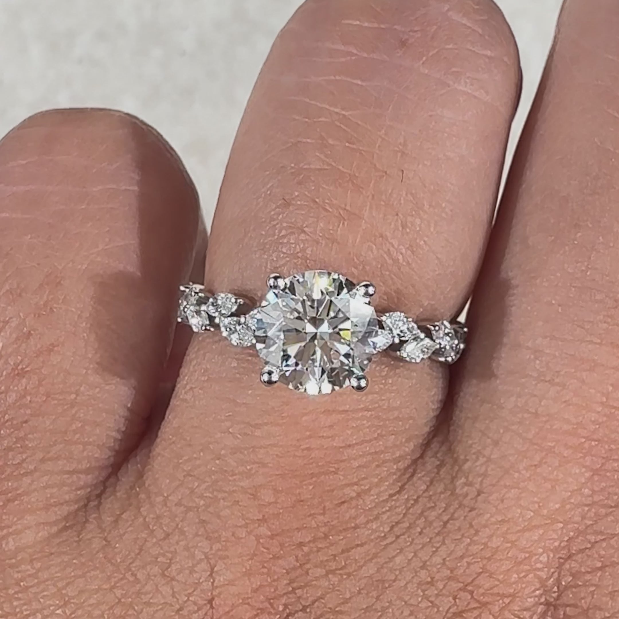 Avideri engagement ring featuring a round and marquise diamond combination, set in a four prong setting.