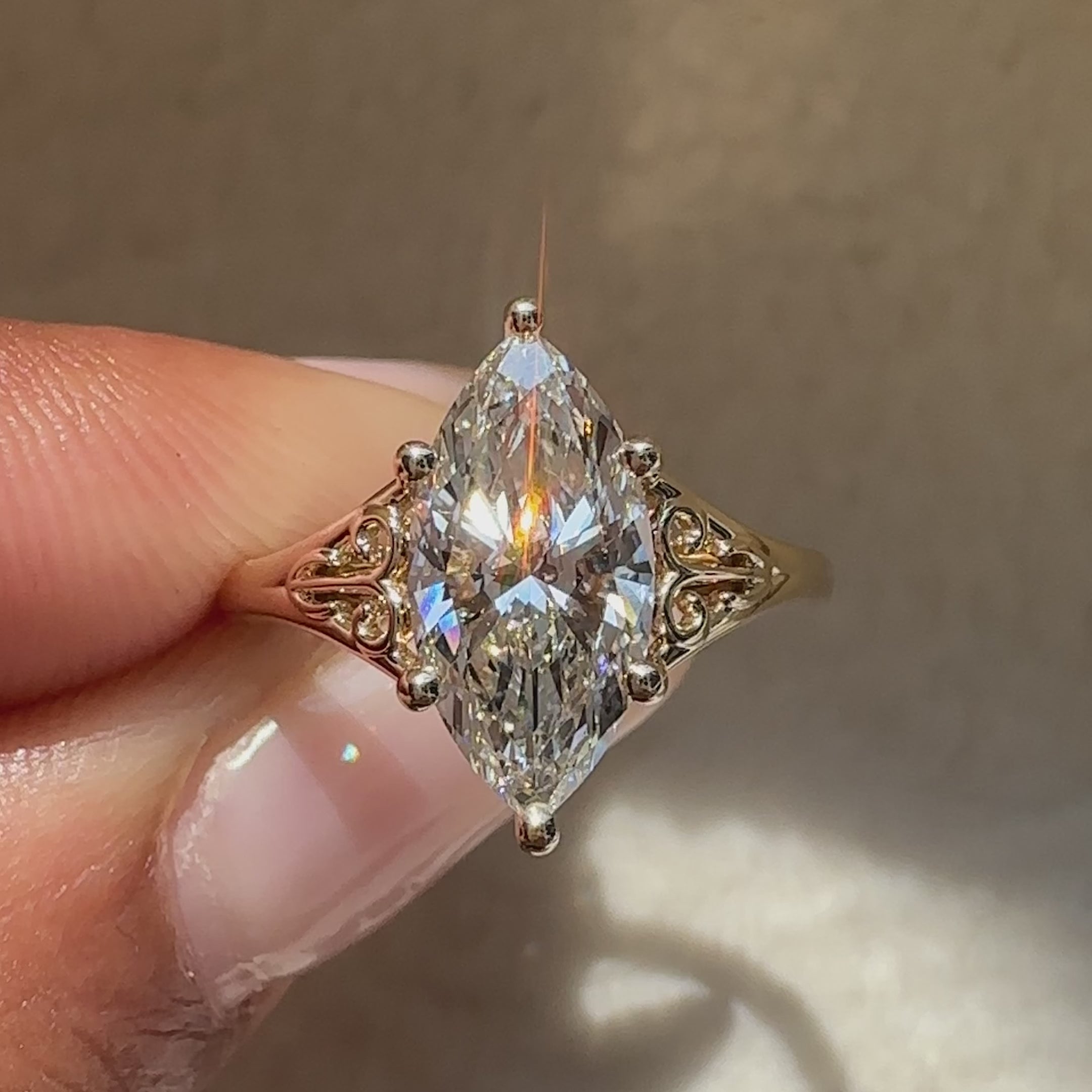 Marquise engagement ring with ornate six prong style.