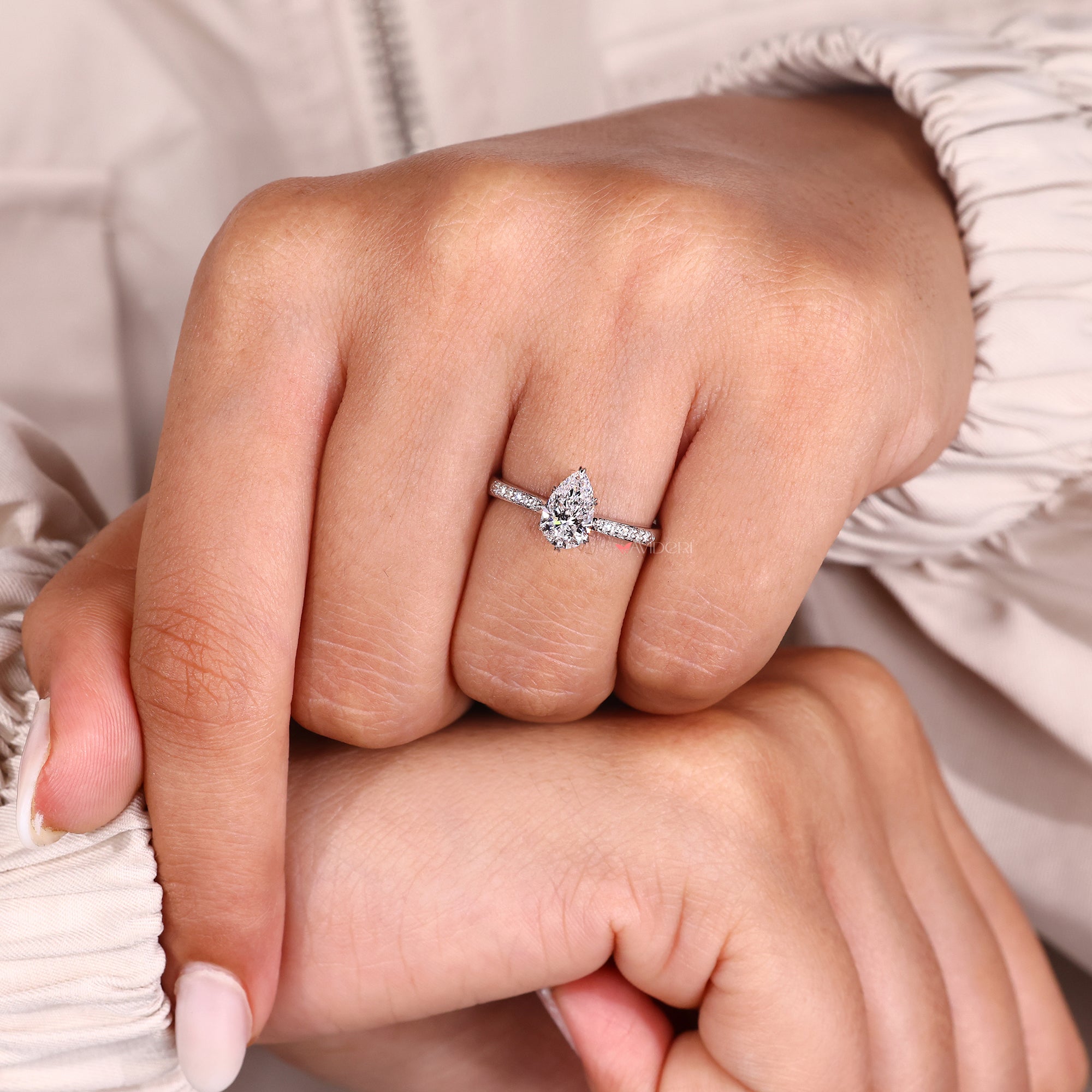 Pear shaped diamond ring with heart prongs.