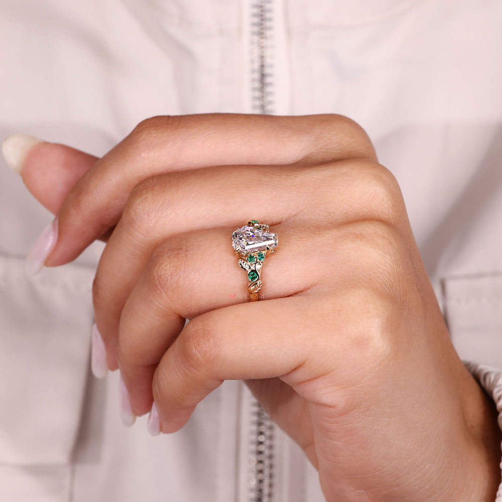 Coffin Cut Ring with round green emeralds.
