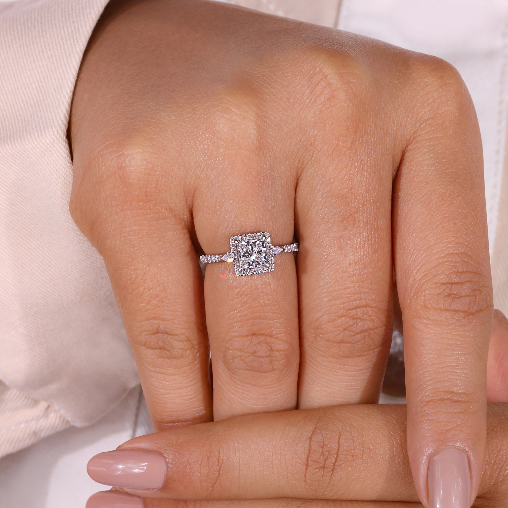 Halo ring with a delicate pave setting that adds sparkle and elegance to the overall design.
