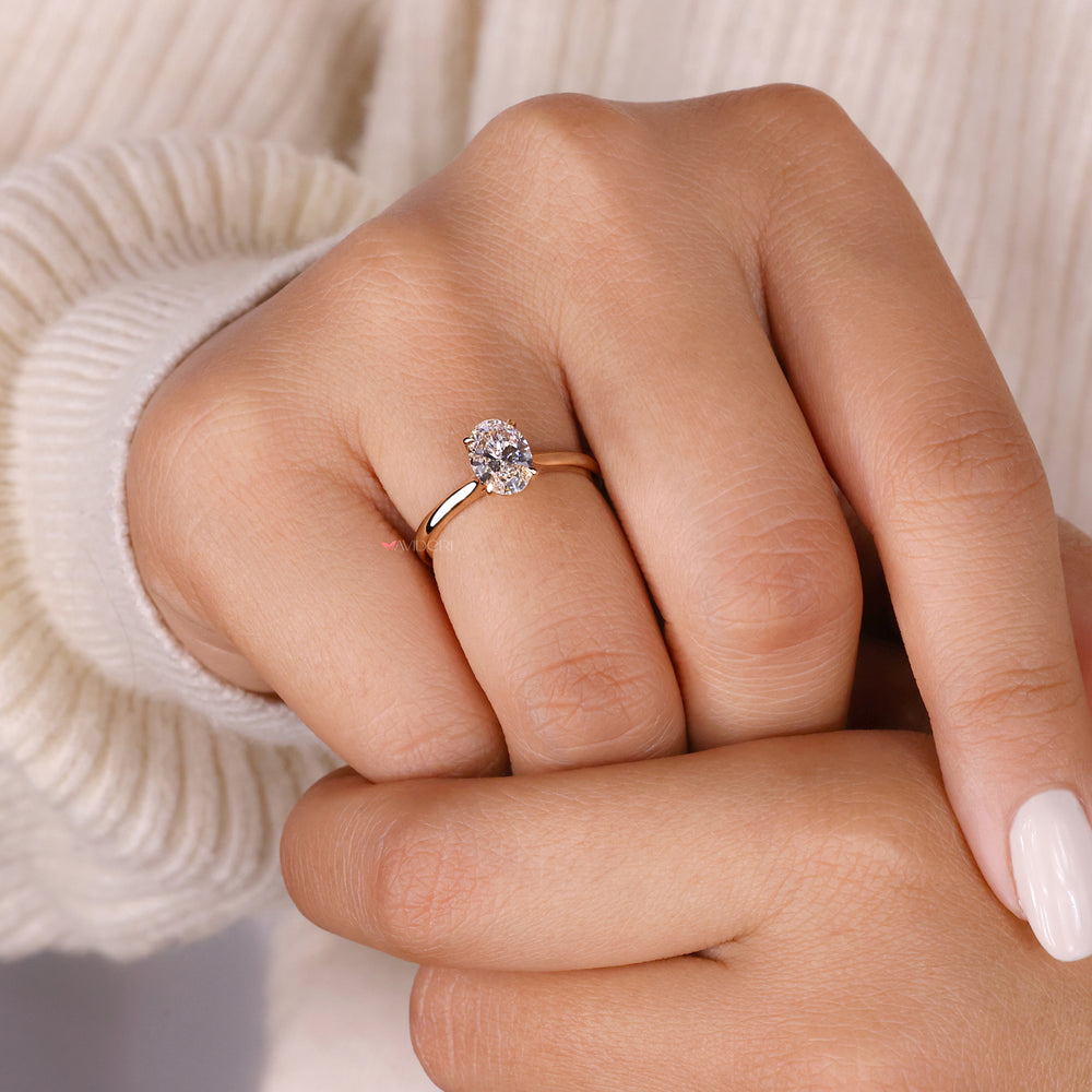 Oval diamond solitaire ring featuring a cathedral setting ring for added sophistication and elegance.
