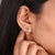 Round and pear diamond earrings in yellow gold earrings.