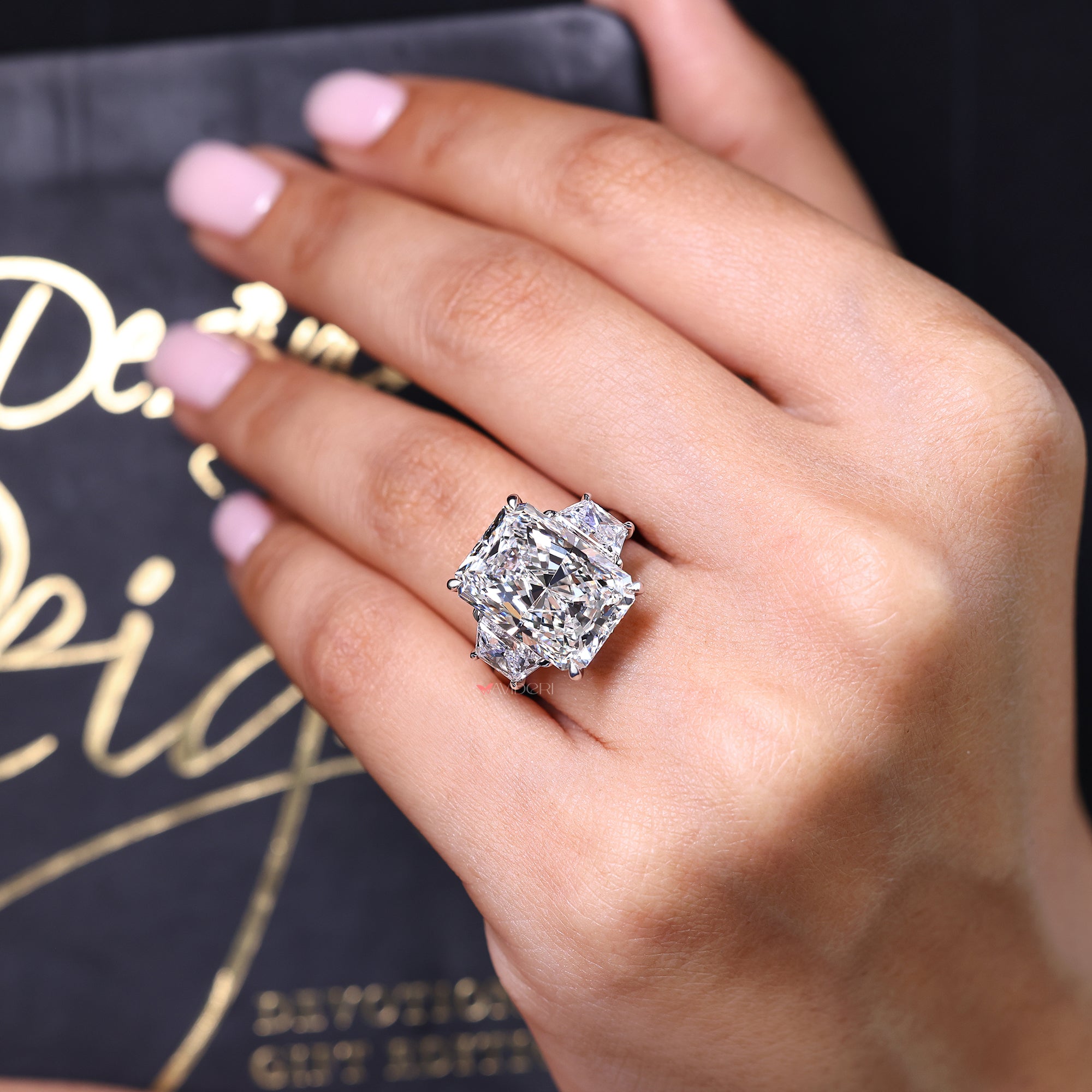 Diamond ring on a hand with a dark background