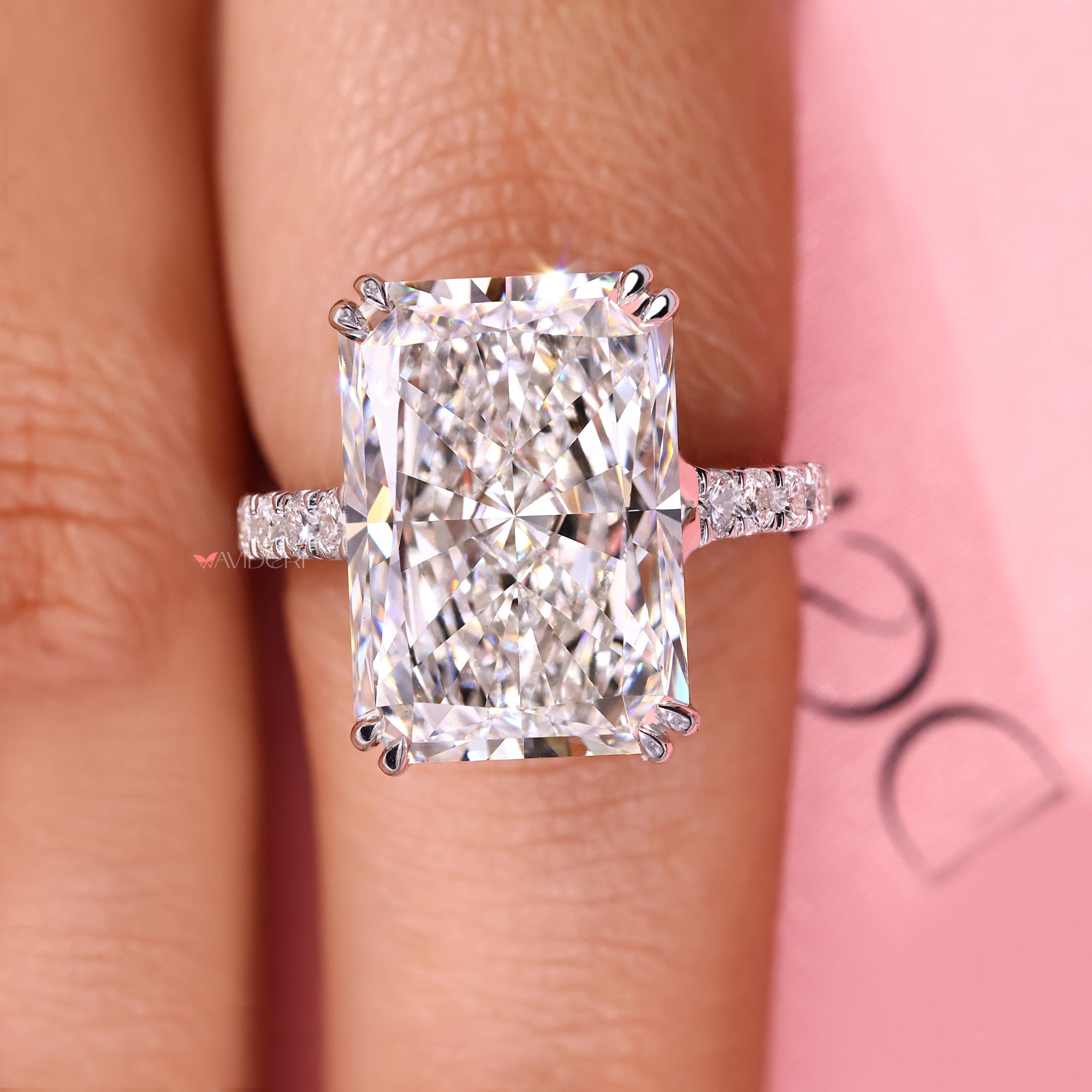 Radiant cut engagement ring with a trellis and pave setting.