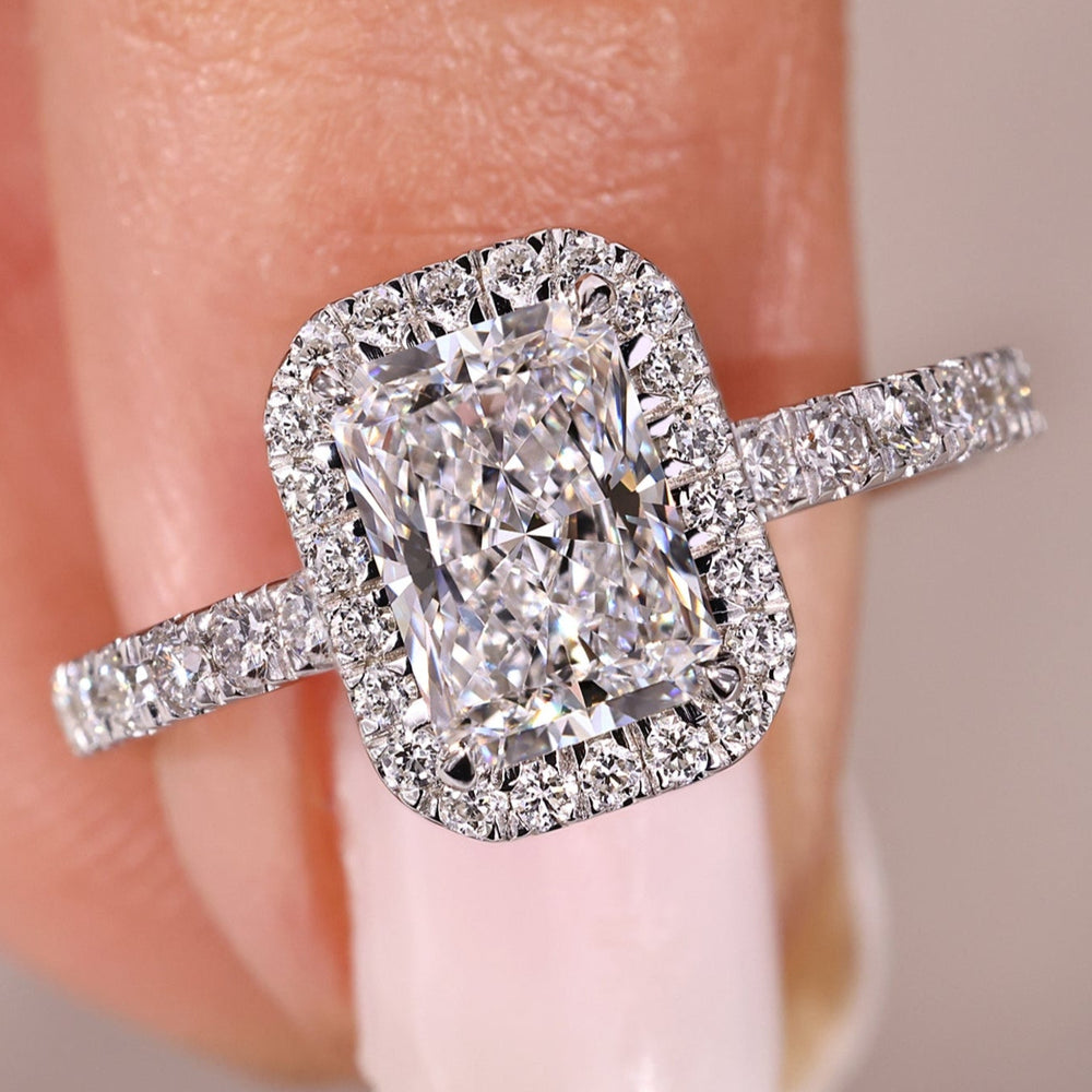 Radiant cut diamond engagement ring with halo setting.