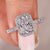 Radiant cut diamond engagement ring with halo setting.