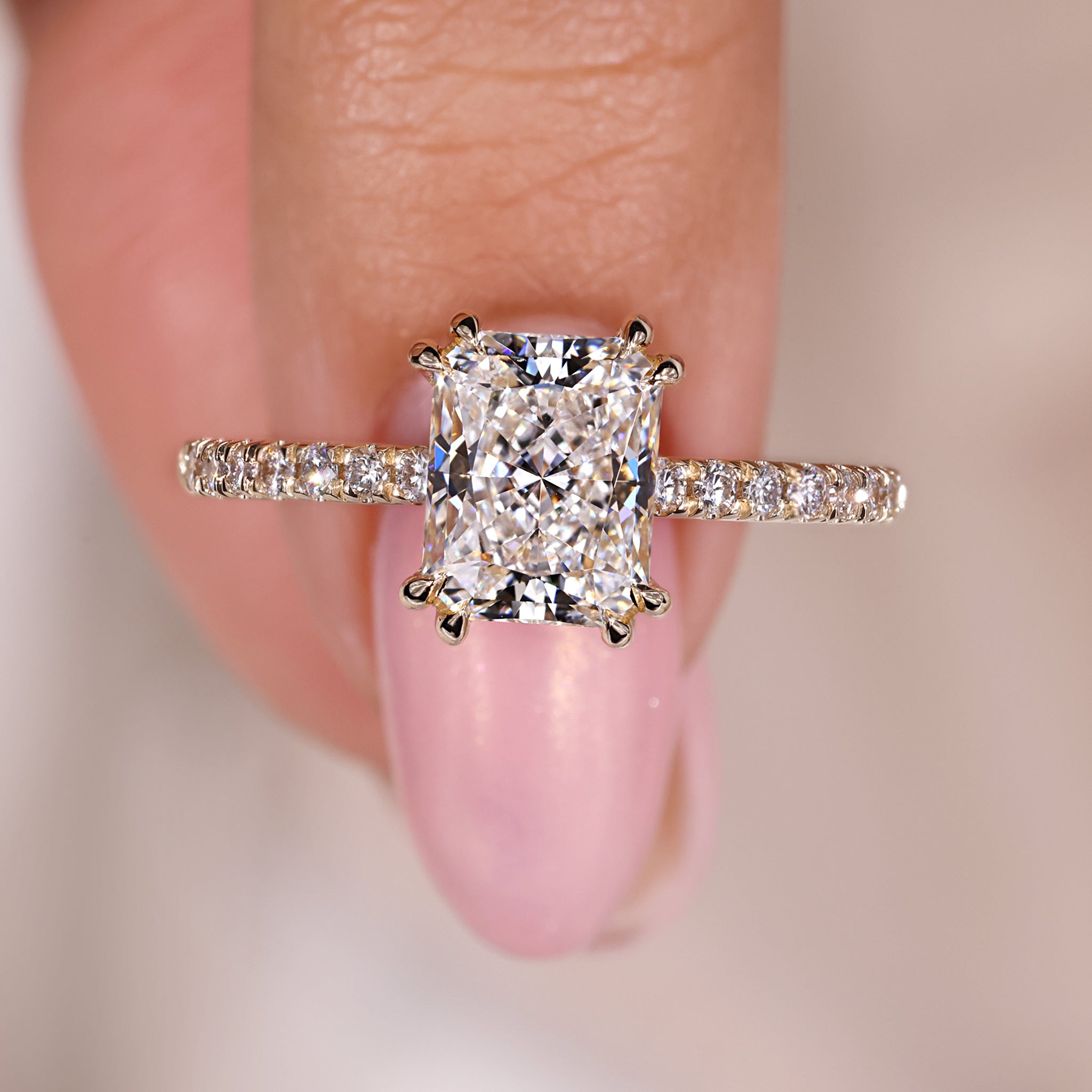 Radiant cut engagement ring with pave setting ring.