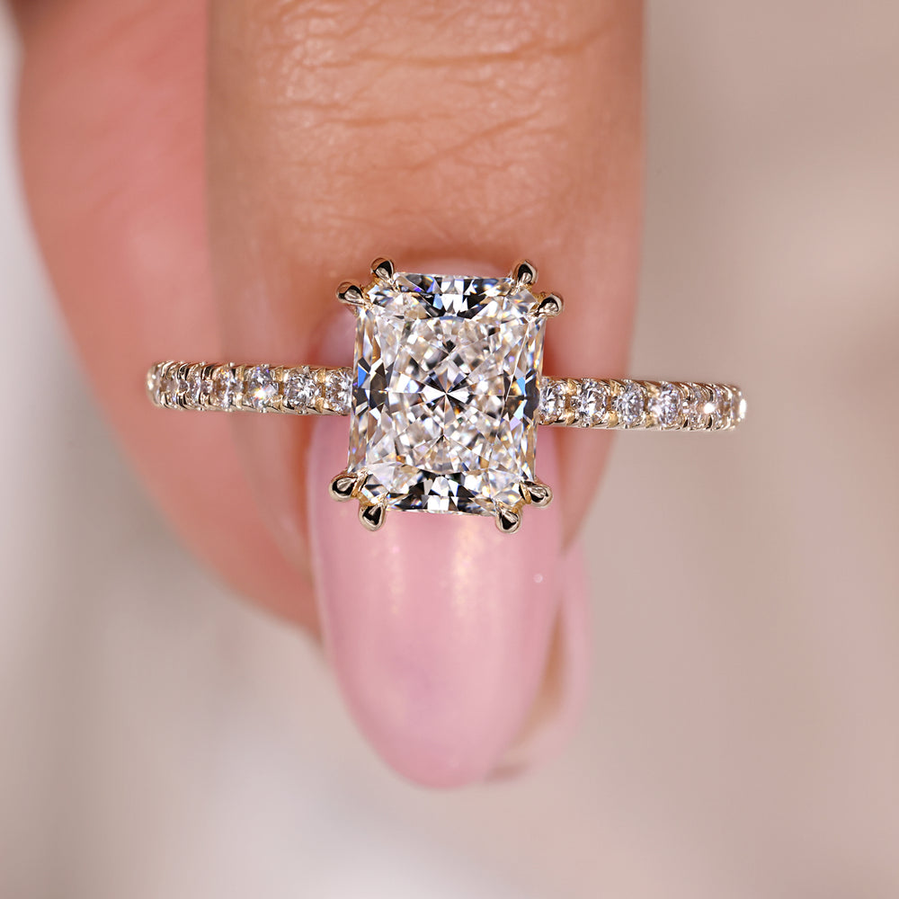 Radiant cut engagement ring with pave setting ring.