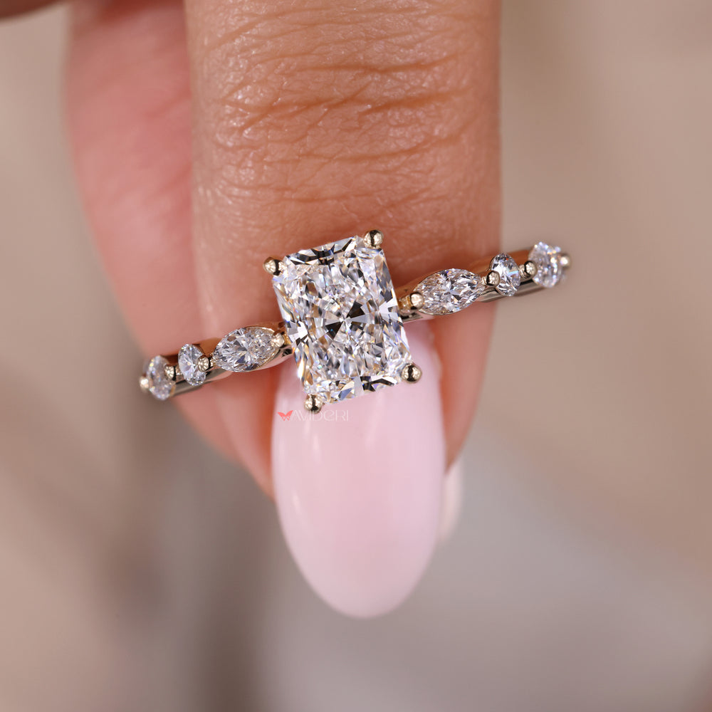 Side stone marquise ring featuring radiant engagement ring and round diamond.
