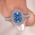 Radiant diamond engagement ring with pave set band.