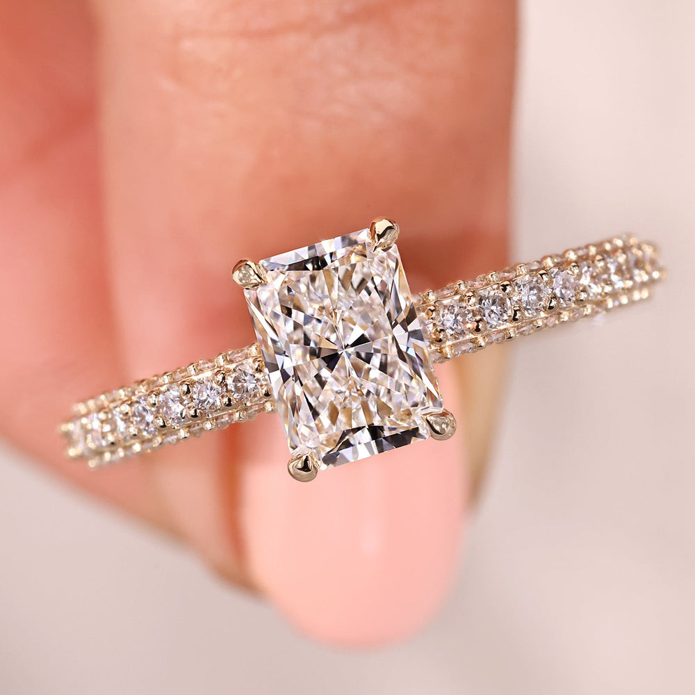 Radiant diamond engagement ring with claw prong setting.