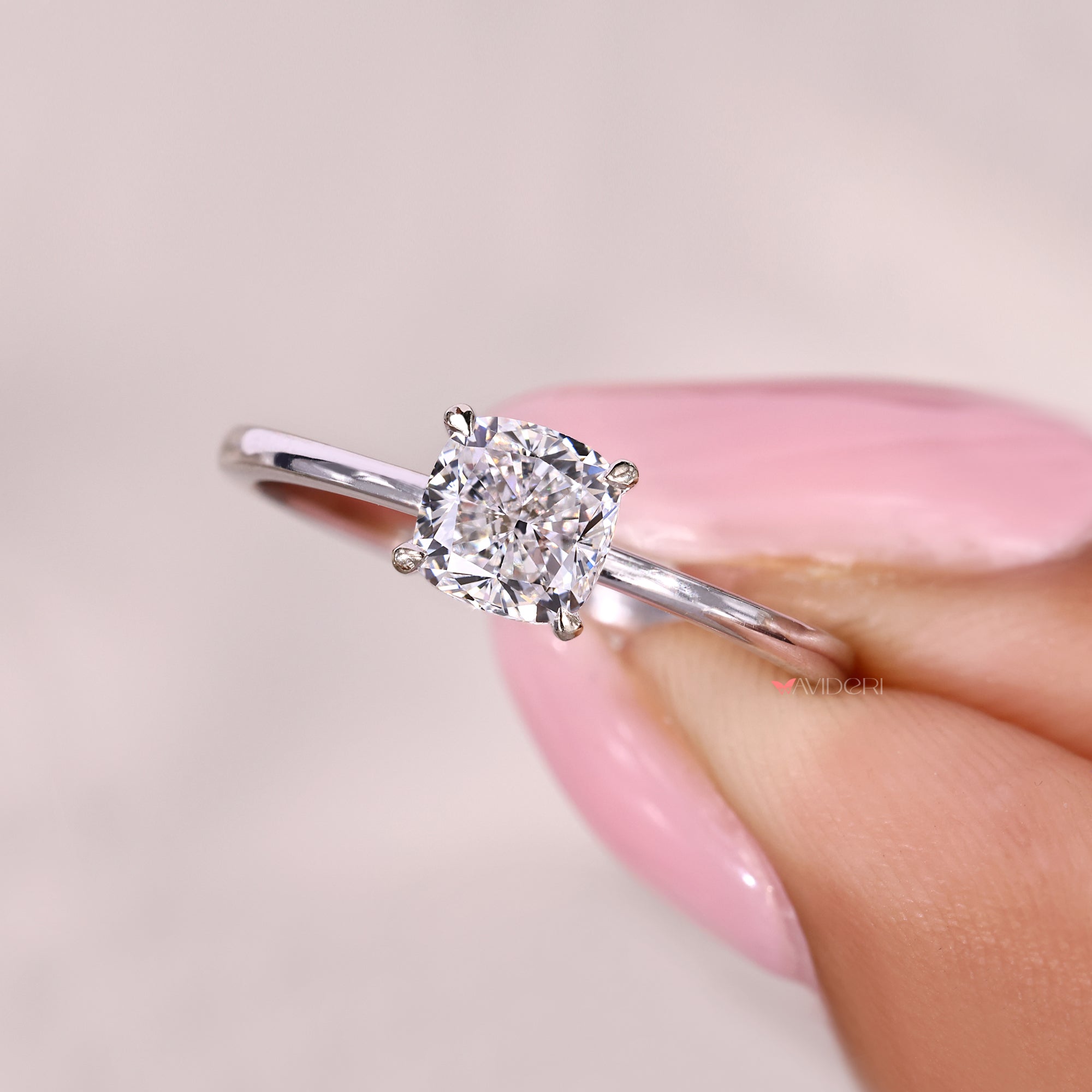Cushion cut diamond solitaire ring with refined profile.