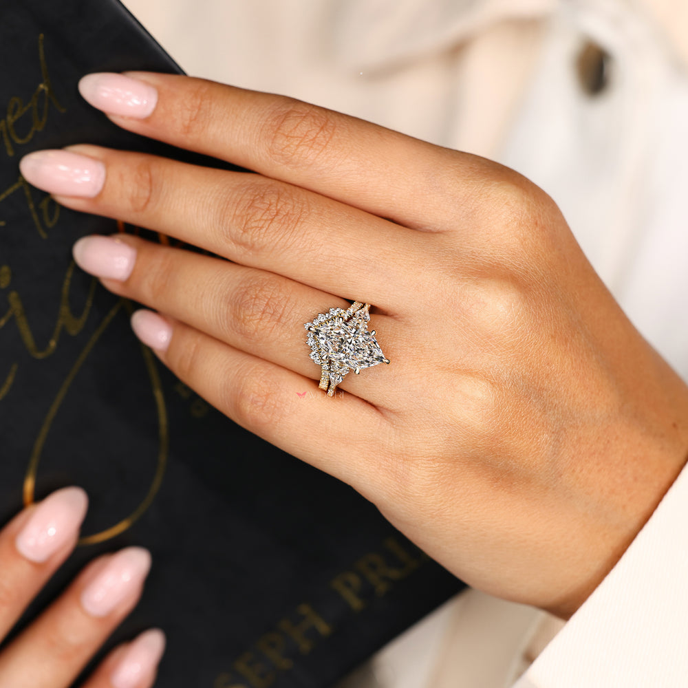 Marquise ring with kite and round side stones.
