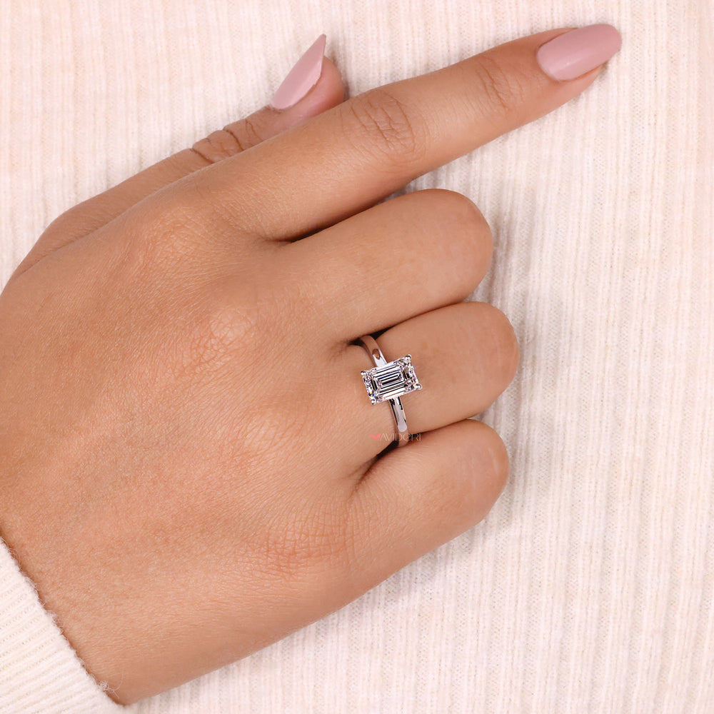 Solitaire engagement ring crafted with an emerald cut diamond and IGI certified quality.
