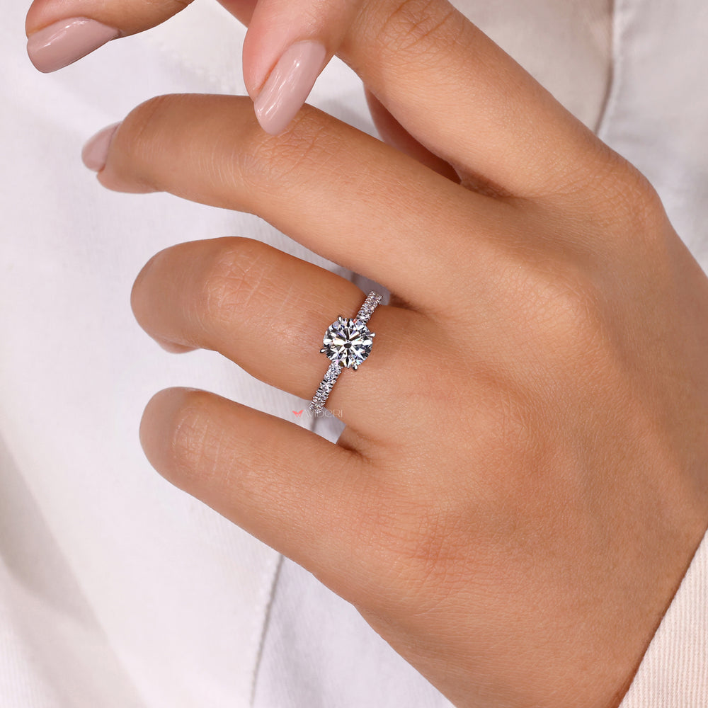 Round diamond in a claw setting ring, offering security and elegance in a handmade design.

