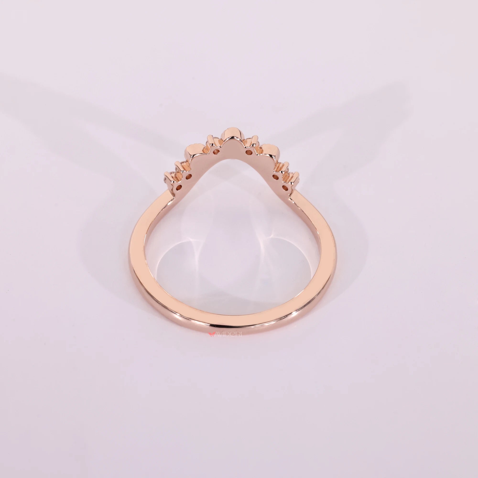 Rose gold diamond band with prong setting.