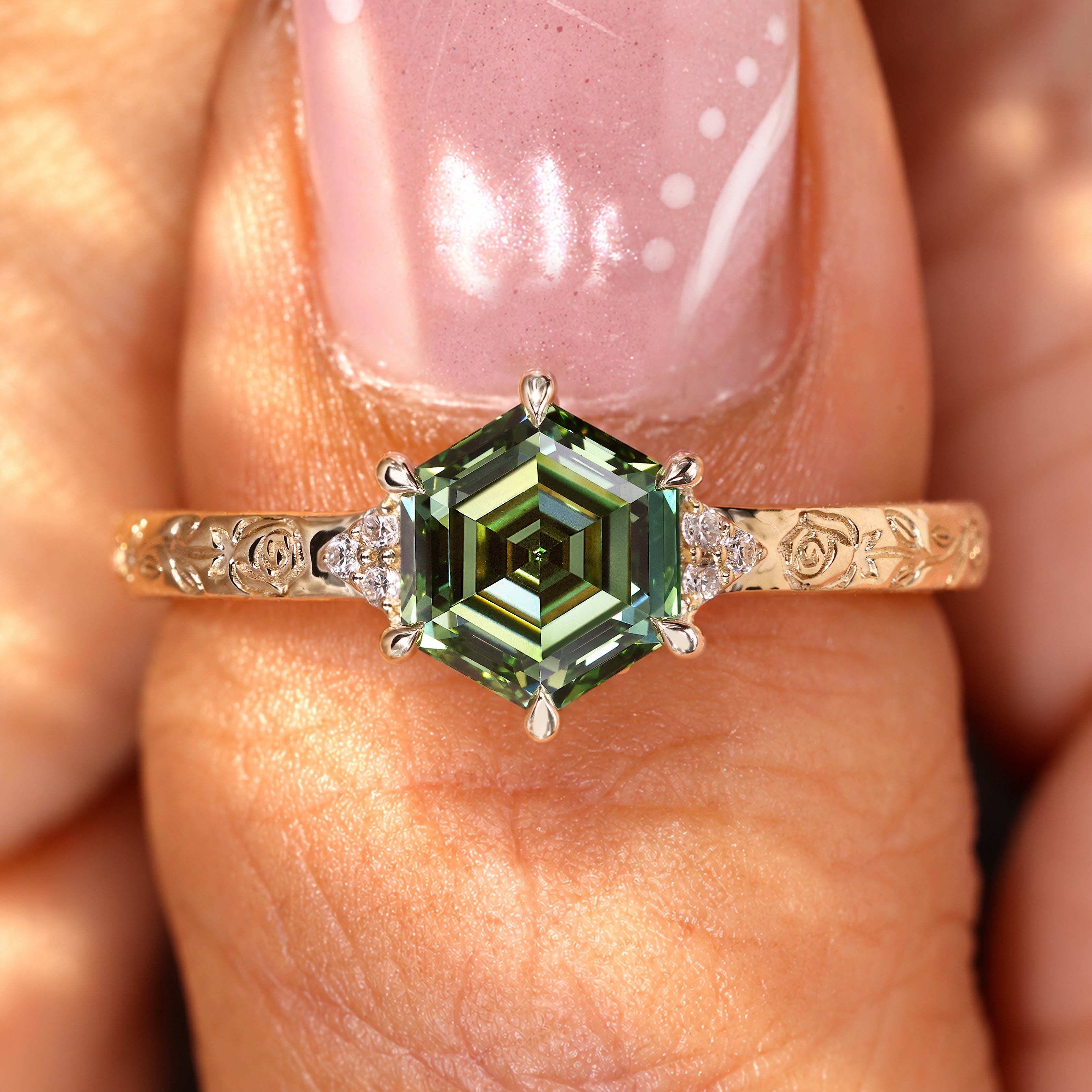 Green diamond ring with six claw prong setting.
